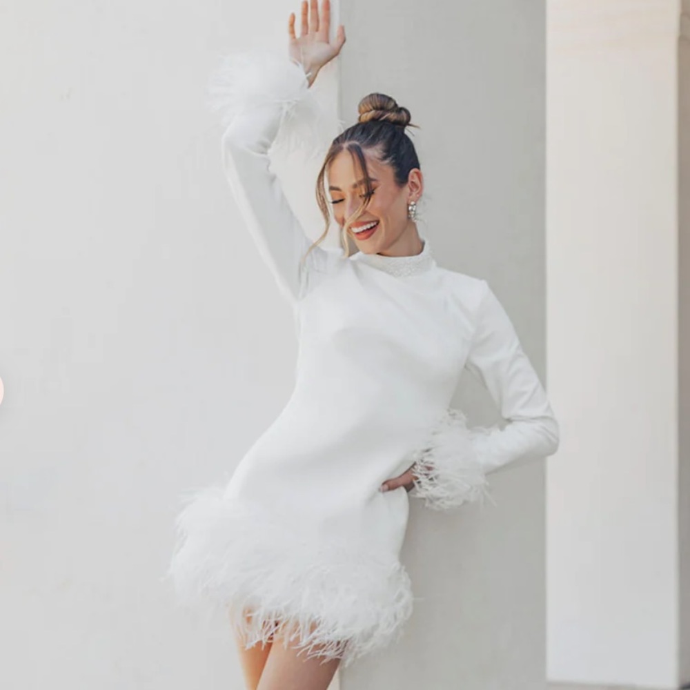 White mini dress with fur trimming from Untamed Petals.